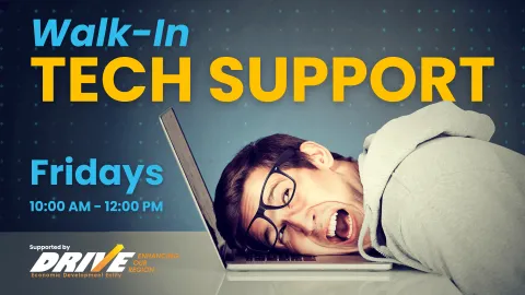 A promotional image for Walk-In Tech Support featuring a frustrated-looking man with his head resting on a laptop keyboard. The text reads 'Walk-In Tech Support' in large yellow and blue letters, with additional details 'Fridays, 10:00 AM - 12:00 PM' and a note of support from DRIVE Economic Development Entity.