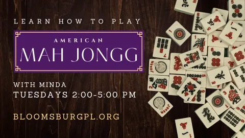 Promotional image for 'Learn How to Play American Mah Jongg' at Bloomsburg Public Library. The text is styled with a purple and gold banner over a wooden background, surrounded by scattered Mah Jongg tiles. Classes are led by Minda on Tuesdays from 2:00 PM to 5:00 PM. The library’s website URL, bloomsburgpl.org, is included at the bottom.